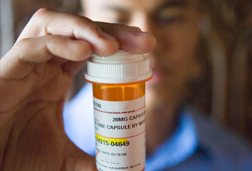 getty rm photo of young man holding pill bottle